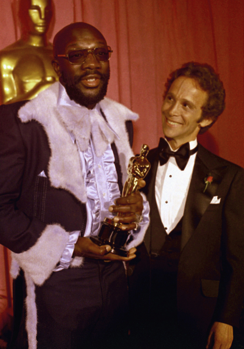 ** FILE ** In this March 27, 1971 file photo, Isaac Hayes, left holds his Oscar for best song as Joel Gray looks on at the Academy Awards, at the Dorothy Chandler Pavilion, Los Angeles. Hayes, the pioneering singer, songwriter and musician whose relentless "Theme From Shaft" won Academy and Grammy awards died Sunday Aug. 10, 2008. He was 65. (AP Photo/File)